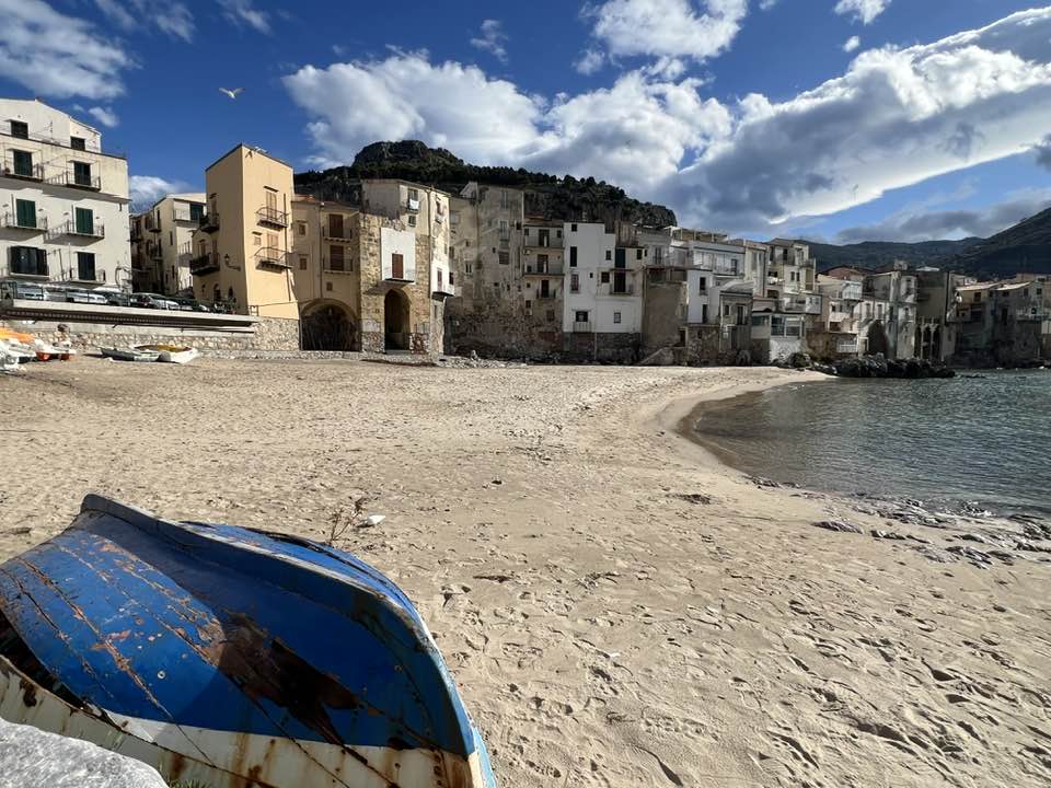 Panoramic view of Cefalù in northern Sicily, featuring its historic town, traditional architecture and Mediterranean coastline.