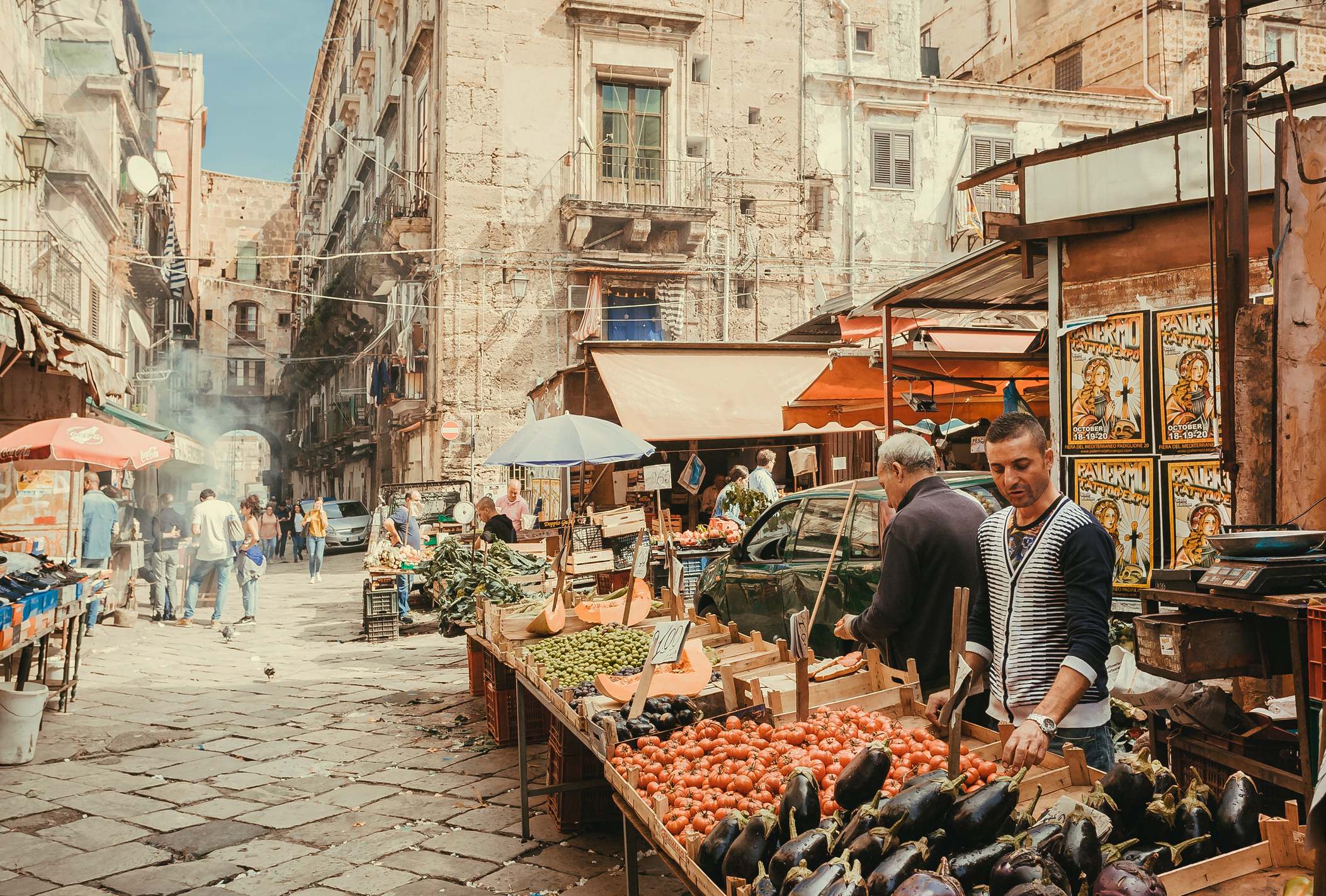 Traditional street market in Palermo, Sicily, with colorful food stalls and local produce reflecting the city's culinary heritage.